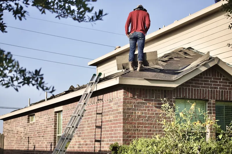 Professional roofer working on a residential roof in Holiday Hill